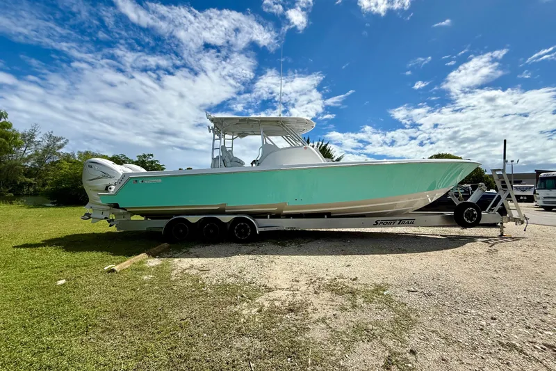  Yacht Photos Pics 2023 Contender 39 Fisharound boat on trailer under blue sky.