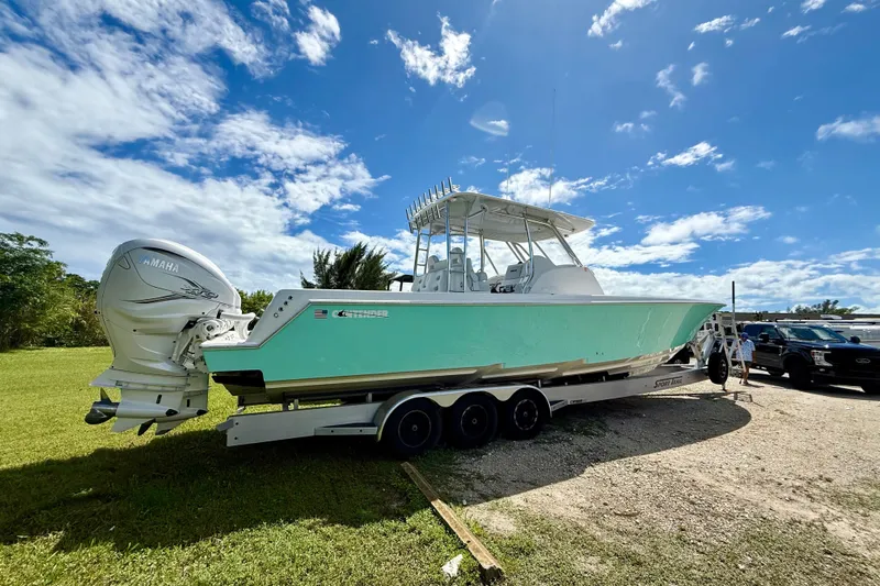  Yacht Photos Pics 2023 Contender 39 Fisharound boat on trailer, parked outdoors under a blue sky.