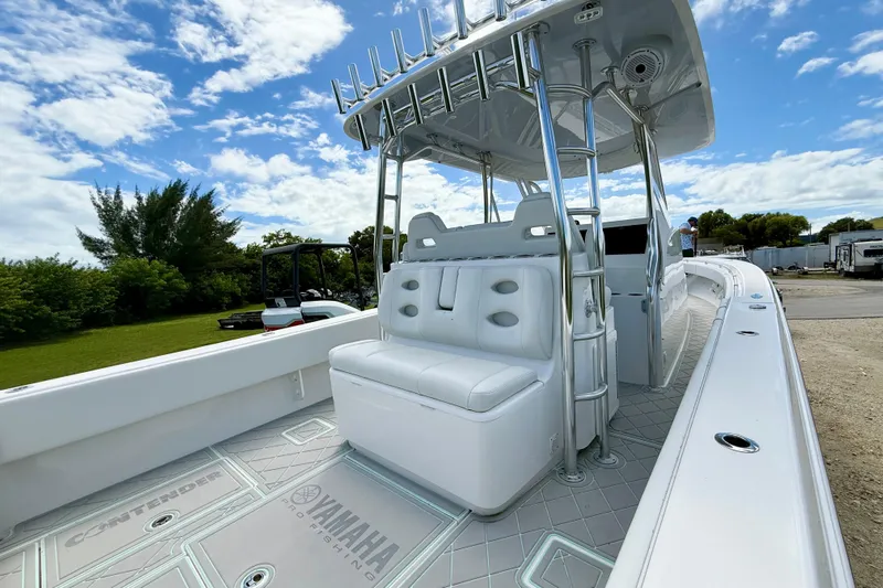  Yacht Photos Pics 2023 Contender 39 Fisharound boat with sleek design and spacious seating under a blue sky.