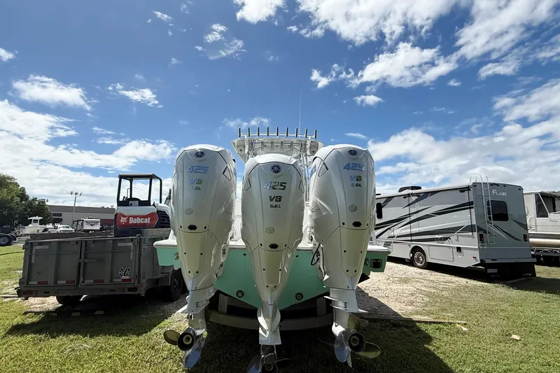  Yacht Photos Pics 2023 Contender 39 Fisharound with triple 425 V8 engines, parked outdoors under a blue sky.