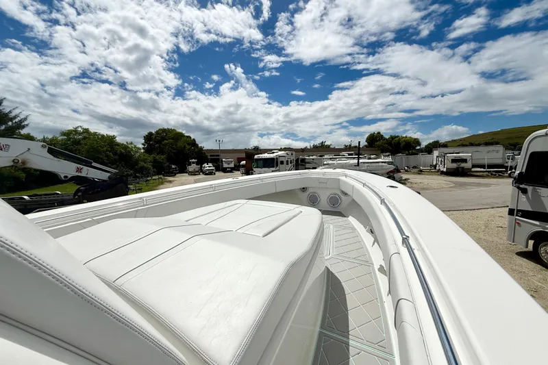  Yacht Photos Pics 2023 Contender 39 Fisharound boat with sleek white deck under a partly cloudy sky.
