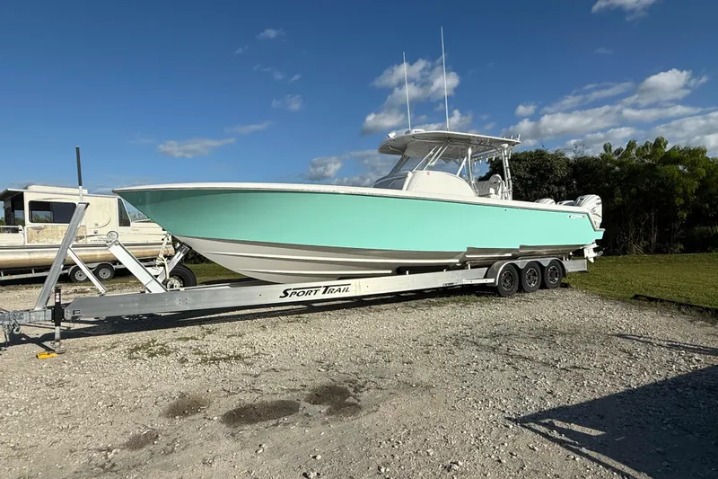  Yacht Photos Pics 2023 Contender 39 Fisharound boat on trailer under clear blue sky.
