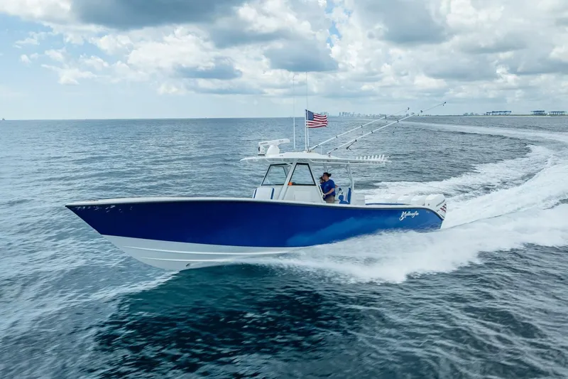  Yacht Photos Pics 2023 Yellowfin 39 Offshore boat cruising on open water under cloudy sky.