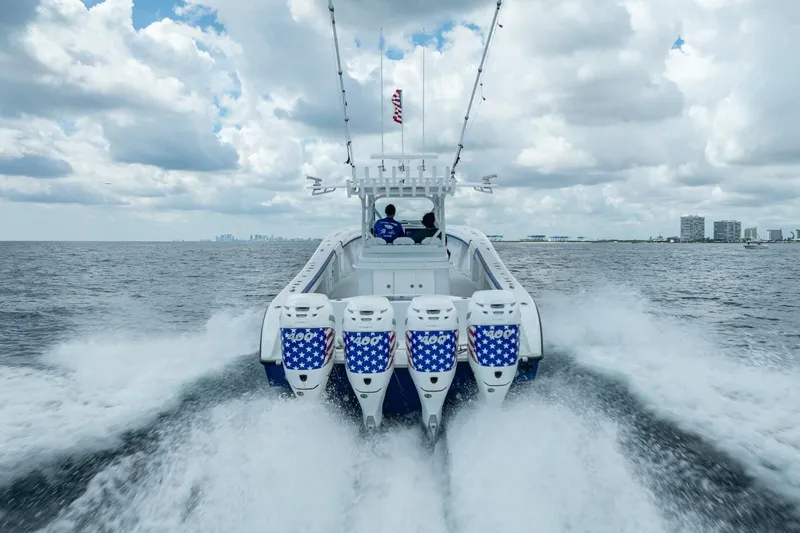  Yacht Photos Pics 2023 Yellowfin 39 Offshore boat speeding on open water under cloudy sky.