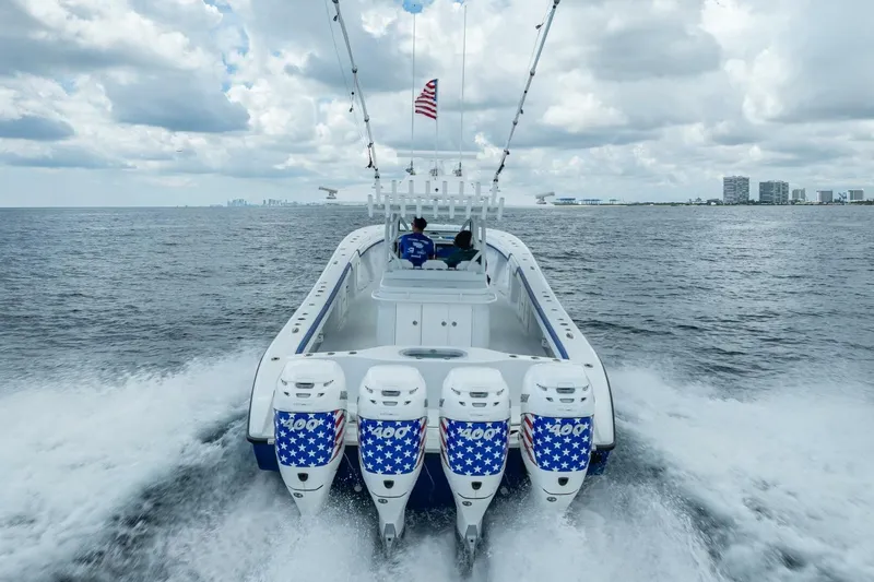  Yacht Photos Pics 2023 Yellowfin 39 Offshore boat cruising with four powerful engines, American flag design.