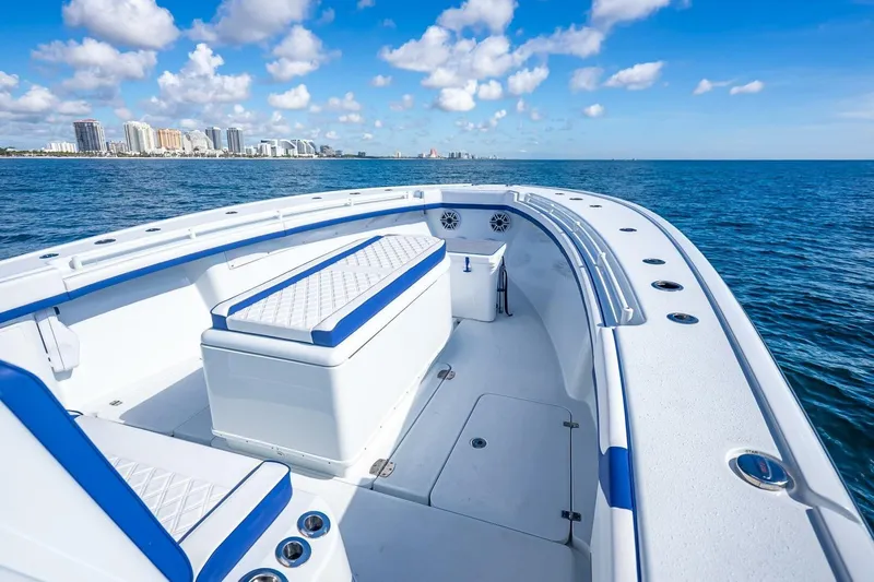  Yacht Photos Pics 2023 Yellowfin 39 Offshore boat on ocean, city skyline in background.