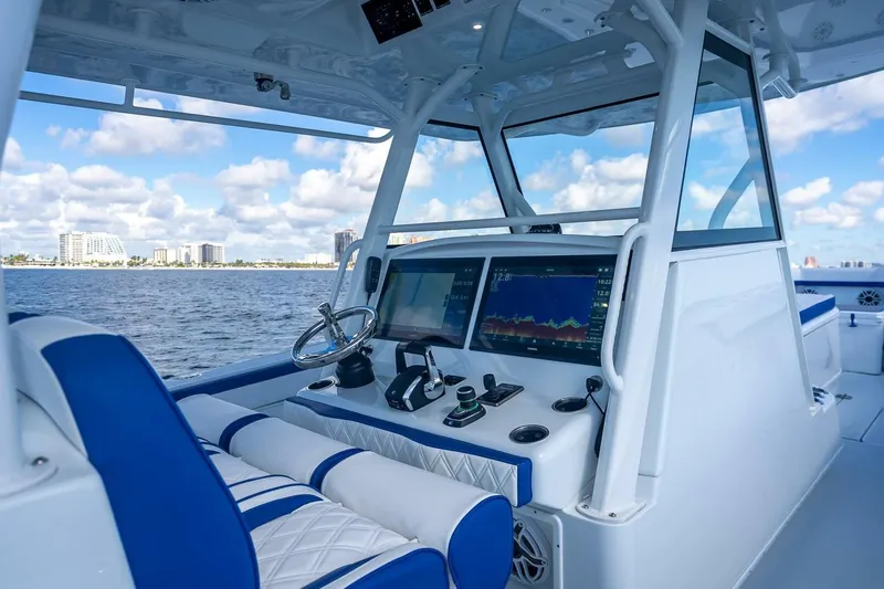  Yacht Photos Pics 2023 Yellowfin 39 Offshore boat cockpit with modern navigation displays and ocean view.