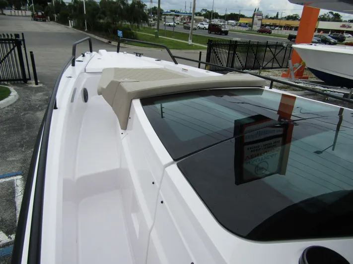  Yacht Photos Pics 2024 Axopar 37XC CROSS CABIN boat, sleek design, docked outdoors.