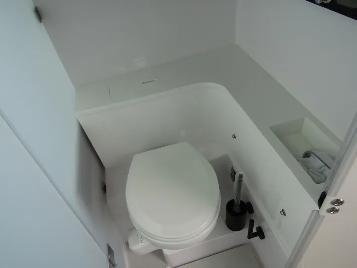  Yacht Photos Pics 2024 Axopar 37XC CROSS CABIN bathroom with modern white toilet and sleek design.