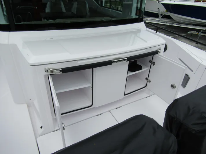  Yacht Photos Pics 2024 Axopar 37XC CROSS CABIN interior storage area with open compartments.