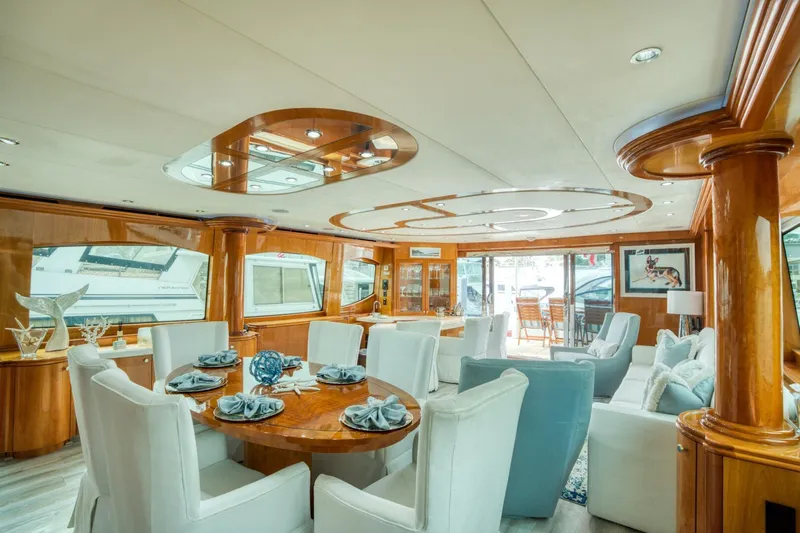 Majestik Yacht Photos Pics Luxurious interior of 2007 Hatteras 80 Enclosed Bridge yacht with elegant dining area.