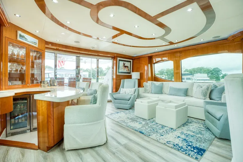Majestik Yacht Photos Pics Luxurious interior of 2007 Hatteras 80 Enclosed Bridge yacht with elegant seating and modern decor.