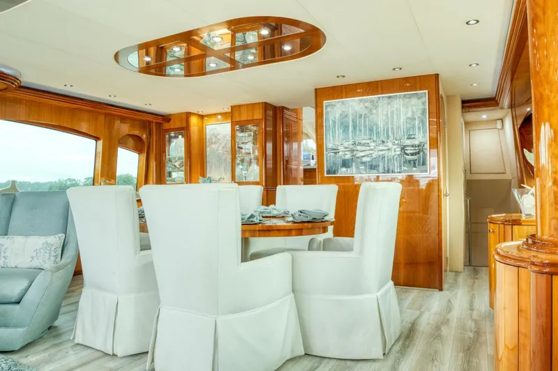 Majestik Yacht Photos Pics Luxurious dining area on 2007 Hatteras 80 Enclosed Bridge yacht with elegant decor.