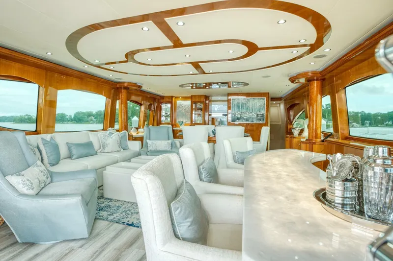 Majestik Yacht Photos Pics Luxurious interior of 2007 Hatteras 80 Enclosed Bridge yacht with elegant seating and decor.