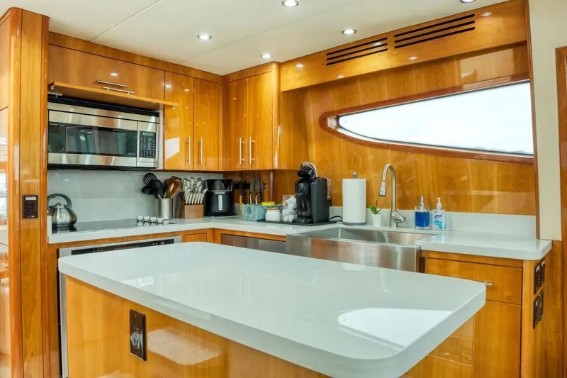 Majestik Yacht Photos Pics Luxurious kitchen interior of 2007 Hatteras 80 Enclosed Bridge yacht with modern appliances.