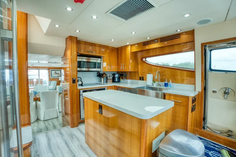 Majestik Yacht Photos Pics Luxurious kitchen interior of 2007 Hatteras 80 Enclosed Bridge yacht, featuring modern appliances.