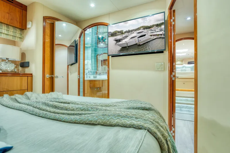 Majestik Yacht Photos Pics Luxurious interior of 2007 Hatteras 80 Enclosed Bridge yacht, featuring elegant bedroom and modern amenities.