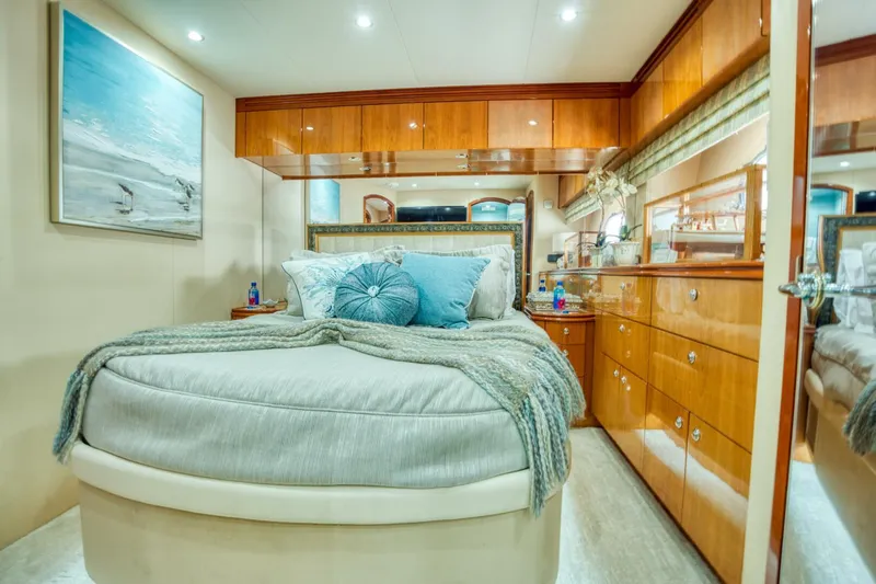 Majestik Yacht Photos Pics Luxurious bedroom interior of 2007 Hatteras 80 Enclosed Bridge yacht with elegant wood finishes.