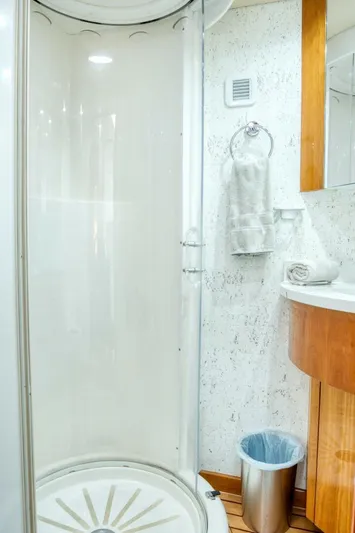 Majestik Yacht Photos Pics Shower area in 2007 Hatteras 80 Enclosed Bridge yacht bathroom, featuring modern amenities.