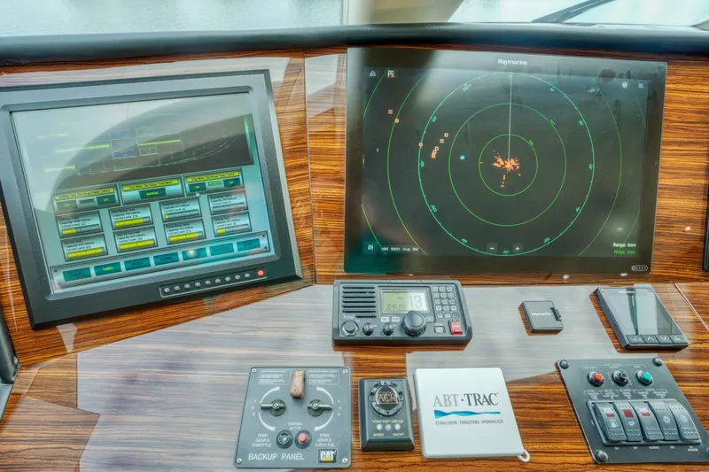 Majestik Yacht Photos Pics Control panel of 2007 Hatteras 80 Enclosed Bridge yacht with navigation screens.