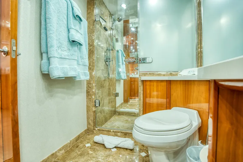 Majestik Yacht Photos Pics Luxurious bathroom on 2007 Hatteras 80 Enclosed Bridge yacht with marble and wood finishes.