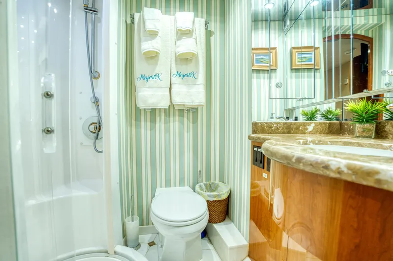 Majestik Yacht Photos Pics Luxurious bathroom on 2007 Hatteras 80 Enclosed Bridge yacht with elegant decor.
