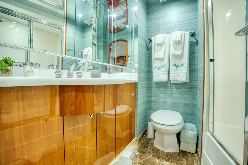 Majestik Yacht Photos Pics Luxurious bathroom in 2007 Hatteras 80 Enclosed Bridge yacht with elegant wood cabinetry.