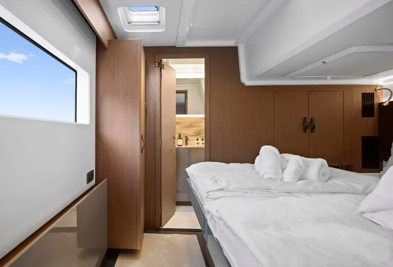  Yacht Photos Pics Luxurious cabin interior of 2024 Prestige M48 yacht with elegant wood finishes and cozy bedding.