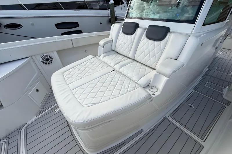 Destroyer Yacht Photos Pics Luxurious seating on a 2018 HCB 39 Speciale boat, featuring quilted white upholstery.