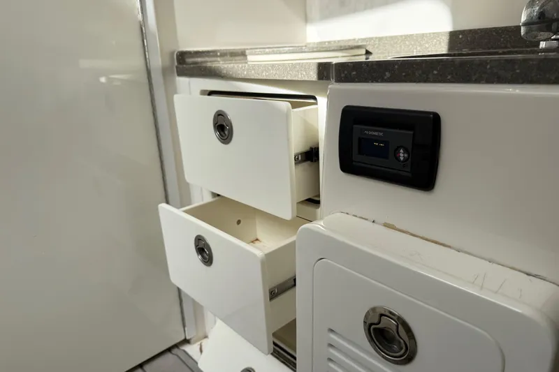 Destroyer Yacht Photos Pics Interior of 2018 HCB 39 Speciale with open drawers and control panel.