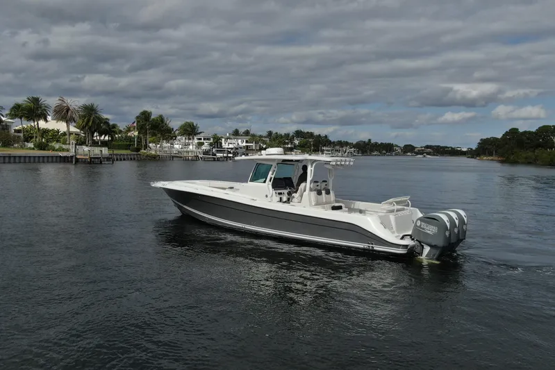 Destroyer Yacht Photos Pics 2018 HCB 39 Speciale boat cruising on a scenic waterway under cloudy skies.