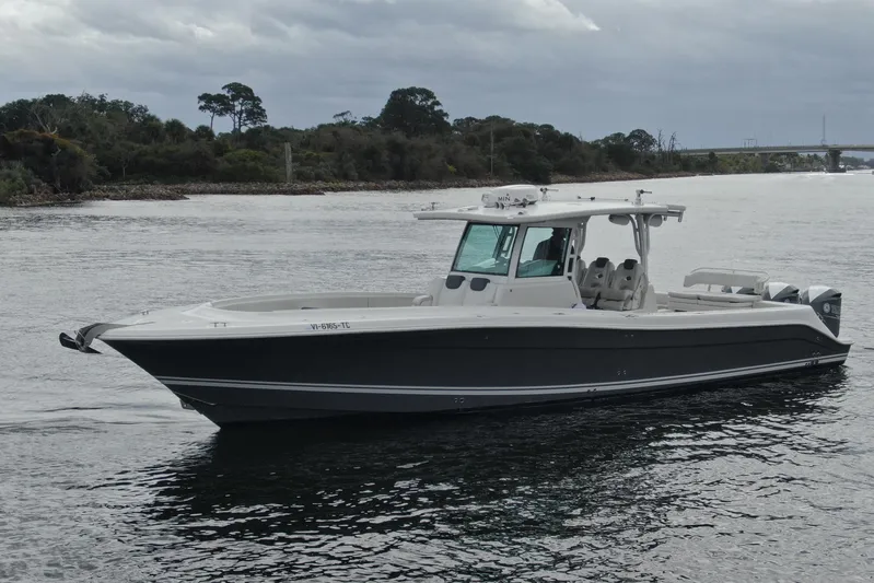 Destroyer Yacht Photos Pics 2018 HCB 39 Speciale boat on calm water, overcast sky, near shoreline.