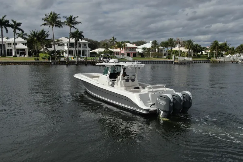Destroyer Yacht Photos Pics 2018 HCB 39 Speciale boat cruising near waterfront homes and palm trees.