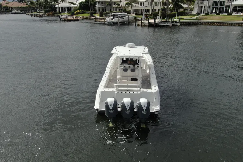 Destroyer Yacht Photos Pics 2018 HCB 39 Speciale boat with triple engines on a calm waterfront.