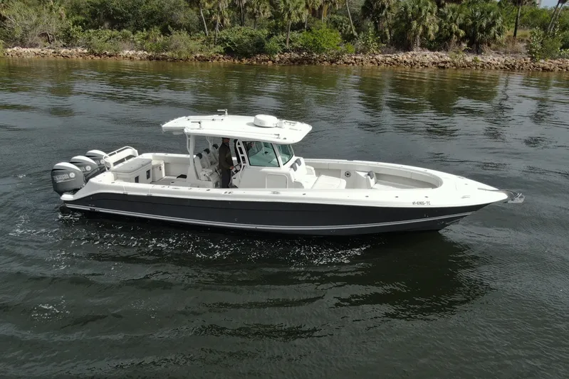 Destroyer Yacht Photos Pics 2018 HCB 39 Speciale boat cruising on calm water with lush greenery in the background.