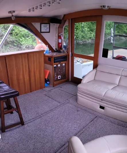 Alika Yacht Photos Pics Interior of a 1983 Ocean Yachts Super Sport with beige seating and wooden accents.