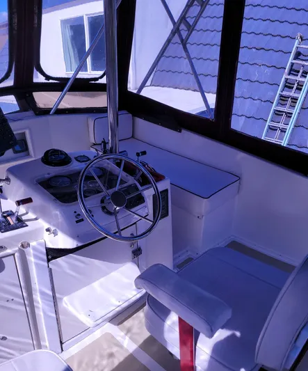 Alika Yacht Photos Pics 1983 Ocean Yachts Super Sport boat interior with steering wheel and seating.