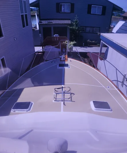 Alika Yacht Photos Pics 1983 Ocean Yachts Super Sport boat docked between houses.