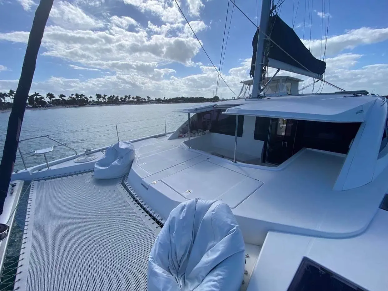 2016 Leopard 48 catamaran on water, featuring spacious deck and seating under a sunny sky.