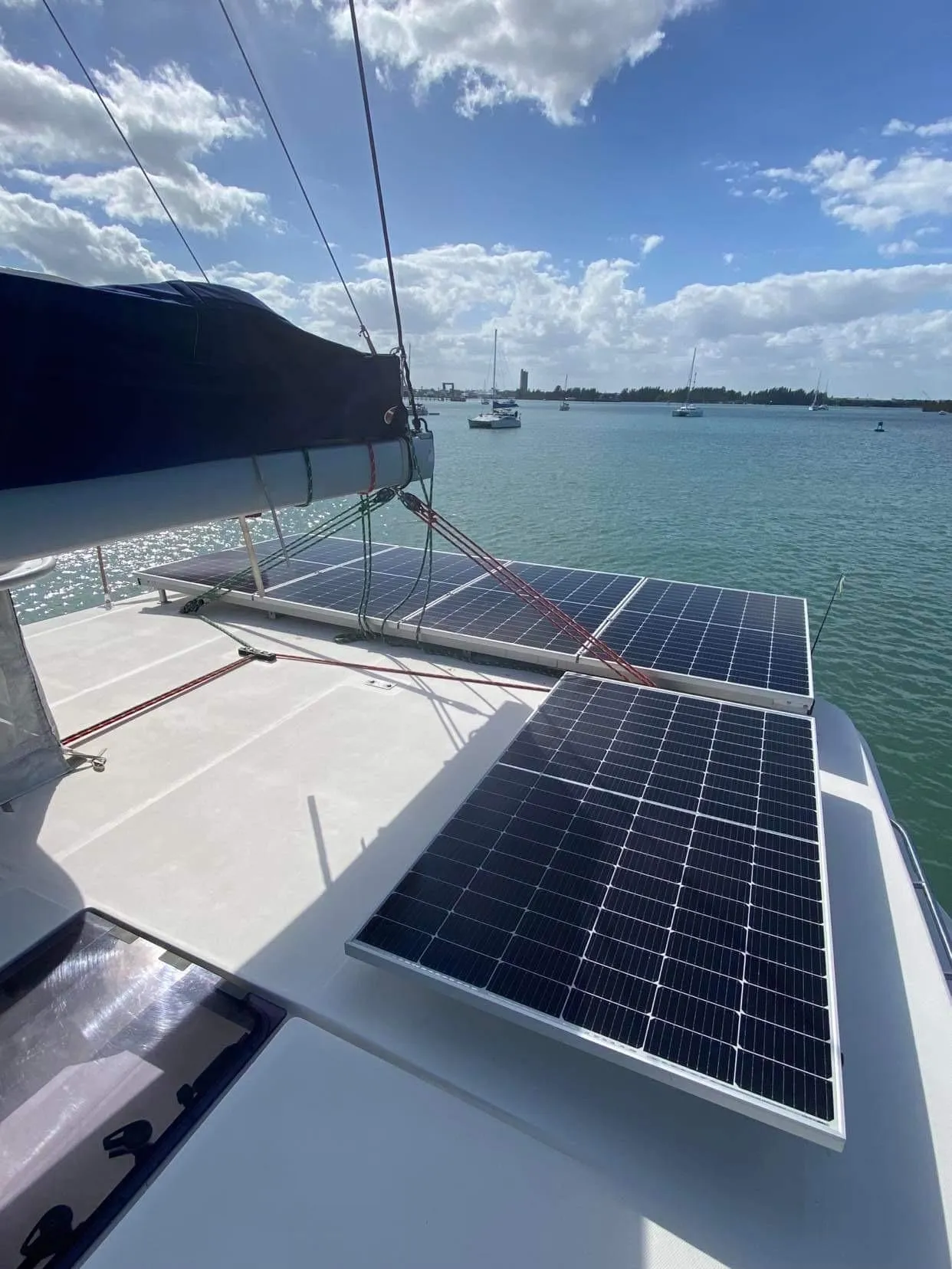 Leopard 48 catamaran with solar panels on deck, sailing in sunny waters.
