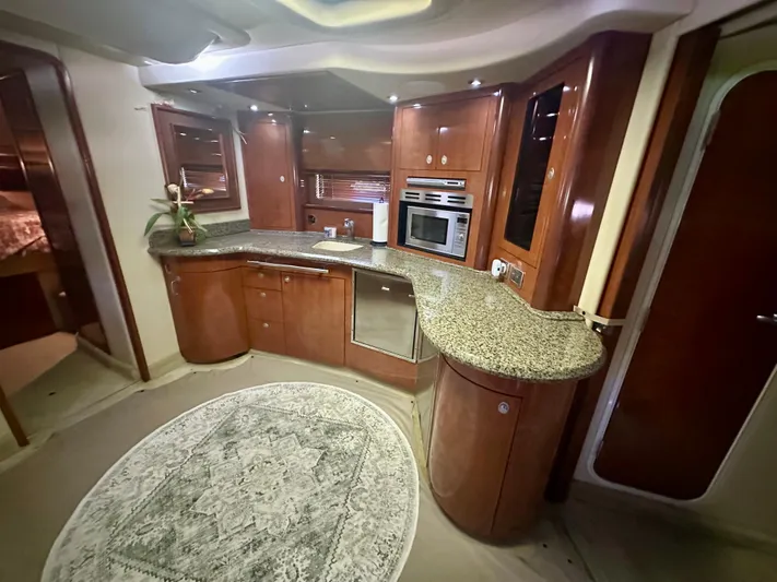  Yacht Photos Pics Luxurious 2005 Sea Ray 420 Sundancer yacht kitchen with granite countertops and wood cabinetry.