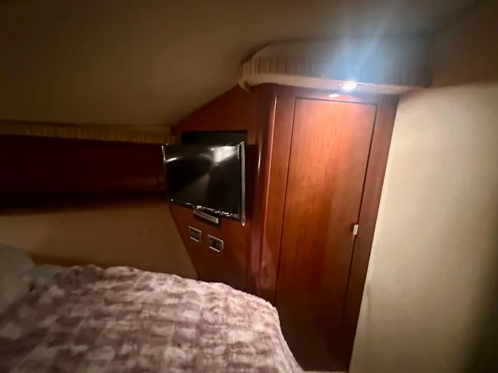  Yacht Photos Pics Interior cabin of 2005 Sea Ray 420 Sundancer with TV and wooden door.