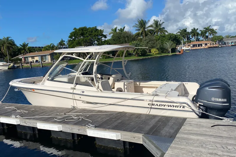  Yacht Photos Pics 2015 Grady-White Freedom 285 boat docked by a scenic waterfront.