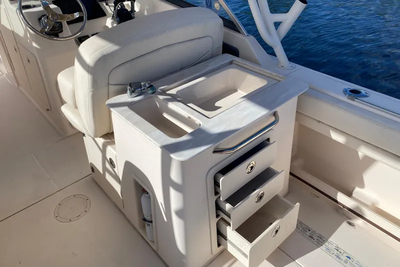  Yacht Photos Pics 2015 Grady-White Freedom 285 boat interior with storage drawers and seating.