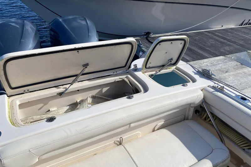  Yacht Photos Pics 2015 Grady-White Freedom 285 boat with open storage compartments at dock.