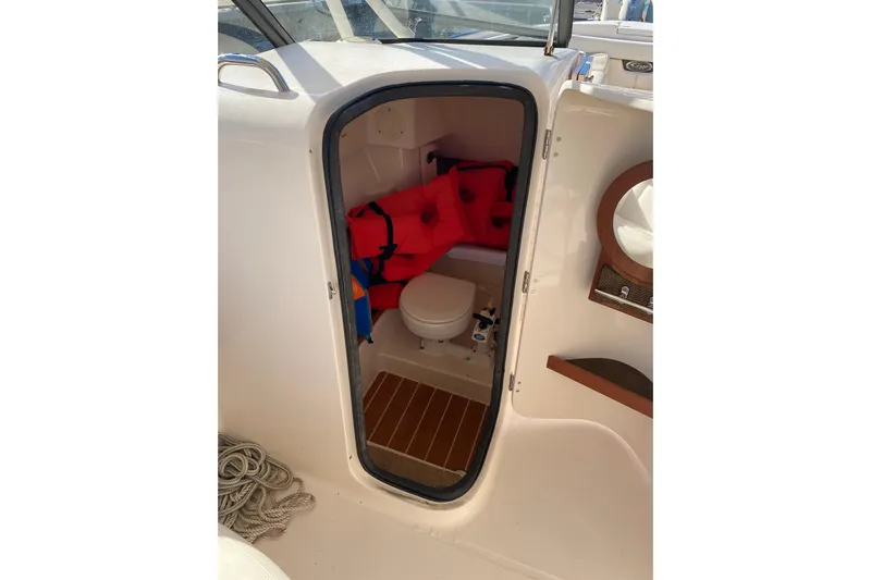  Yacht Photos Pics 2015 Grady-White Freedom 285 boat cabin with life jackets and toilet.