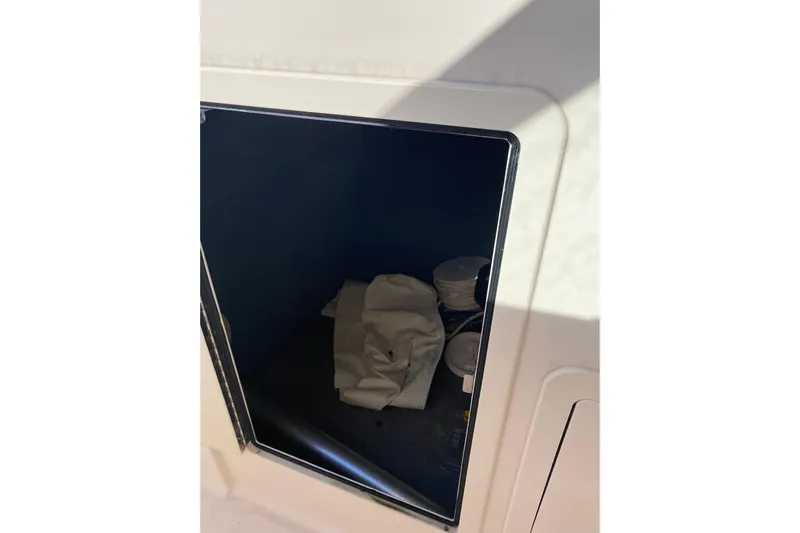  Yacht Photos Pics Storage compartment on 2015 Grady-White Freedom 285 boat with items inside.