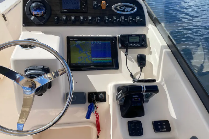  Yacht Photos Pics 2015 Grady-White Freedom 285 boat dashboard with steering wheel, Garmin display, and Yamaha controls.