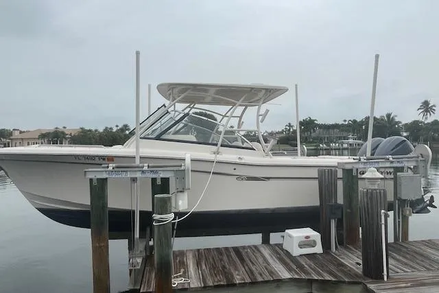  Yacht Photos Pics 2015 Grady-White Freedom 285 boat docked on a lift by the water.