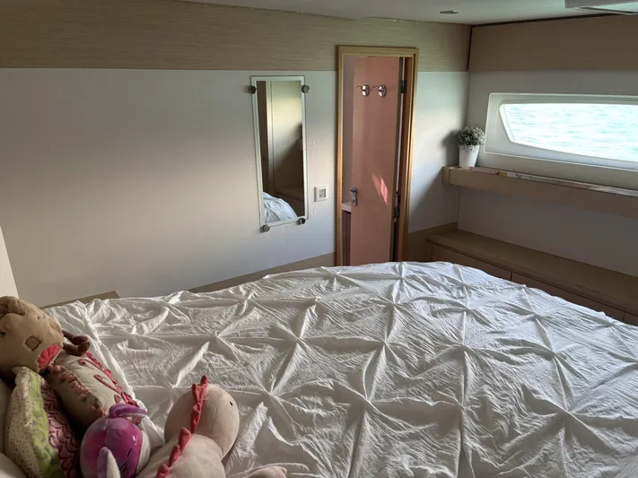 Adventure For Seven Yacht Photos Pics Bedroom interior of 2017 Fountaine Pajot Ipanema 58 yacht with plush toys and window.